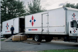 Two Hingham Moving Services box trucks providing local moving services in Boston, MA
