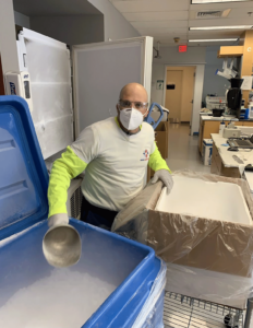 Worker carefully packing frozen specimen with ice as an example of why to choose cryogenic transportation