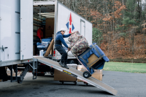 movers loading furniture onto truck after client finds a long-distance moving company