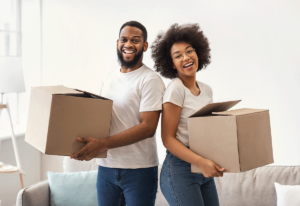 couple holding boxes getting ready for boston moving day